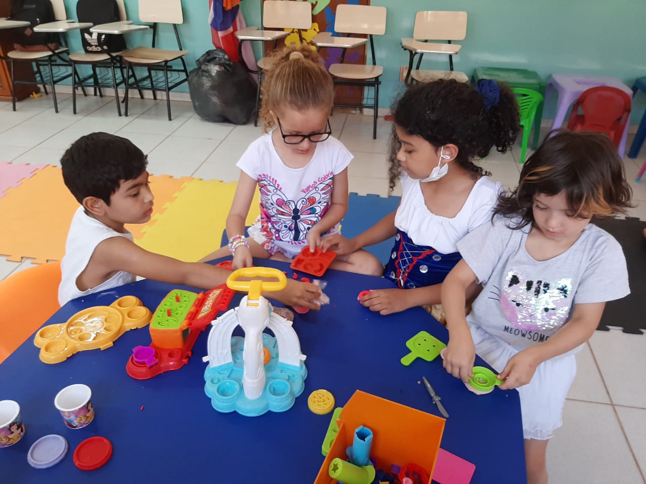 Black kettle with long pour spot and angled body on marble counter next to coffee mug and pour-over system.